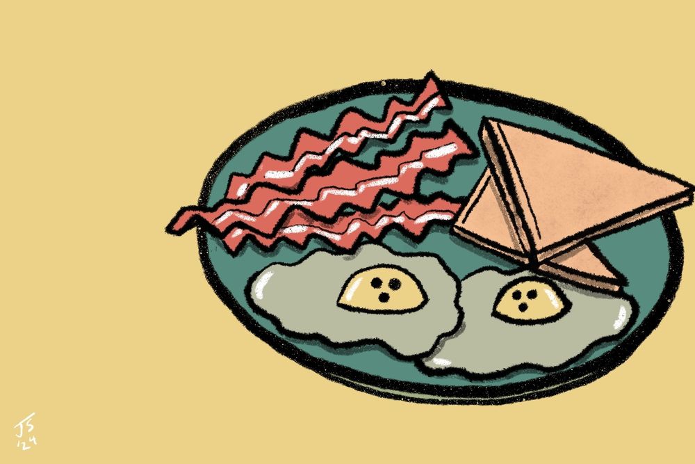 Ghost eggs sit on a plate with toast and bacon