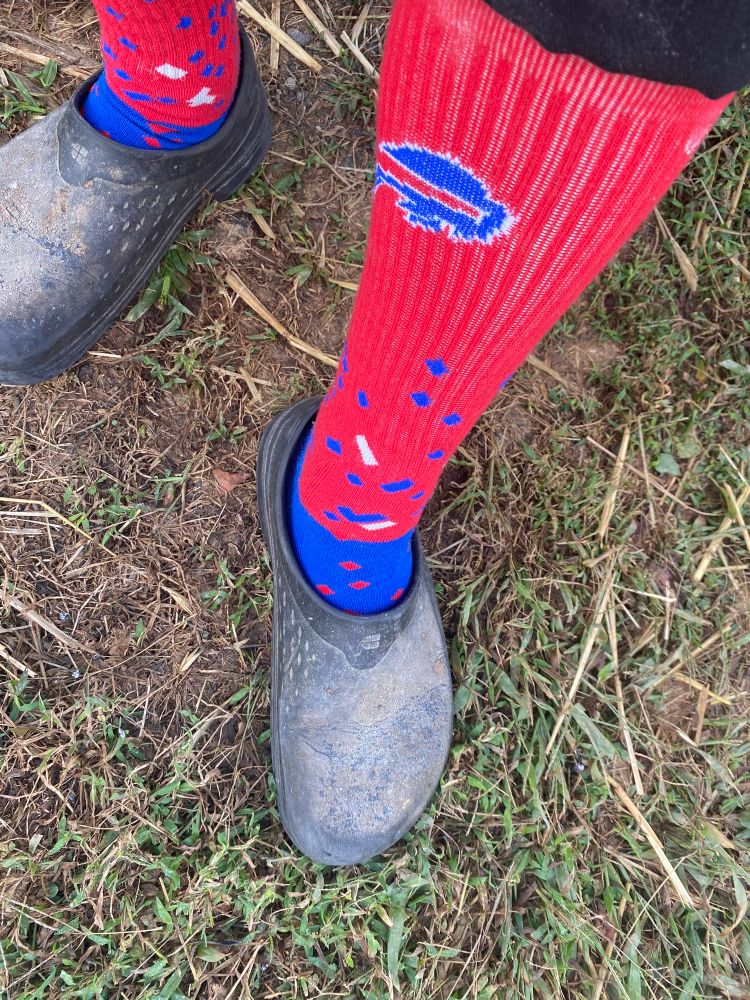 My flour caked work clog with my foot and calf sporting some cool ass Bills socks