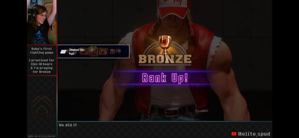 Screenshot from my stream, showing the rank up screen to Bronze 1 in Street Fighter 6. I’m raising my fists in the air in celebration