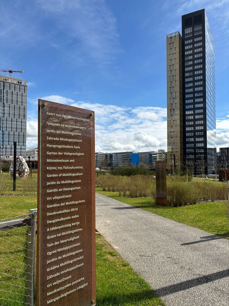 Entrance to the multilingualism garden with a sign in all official EU languages 