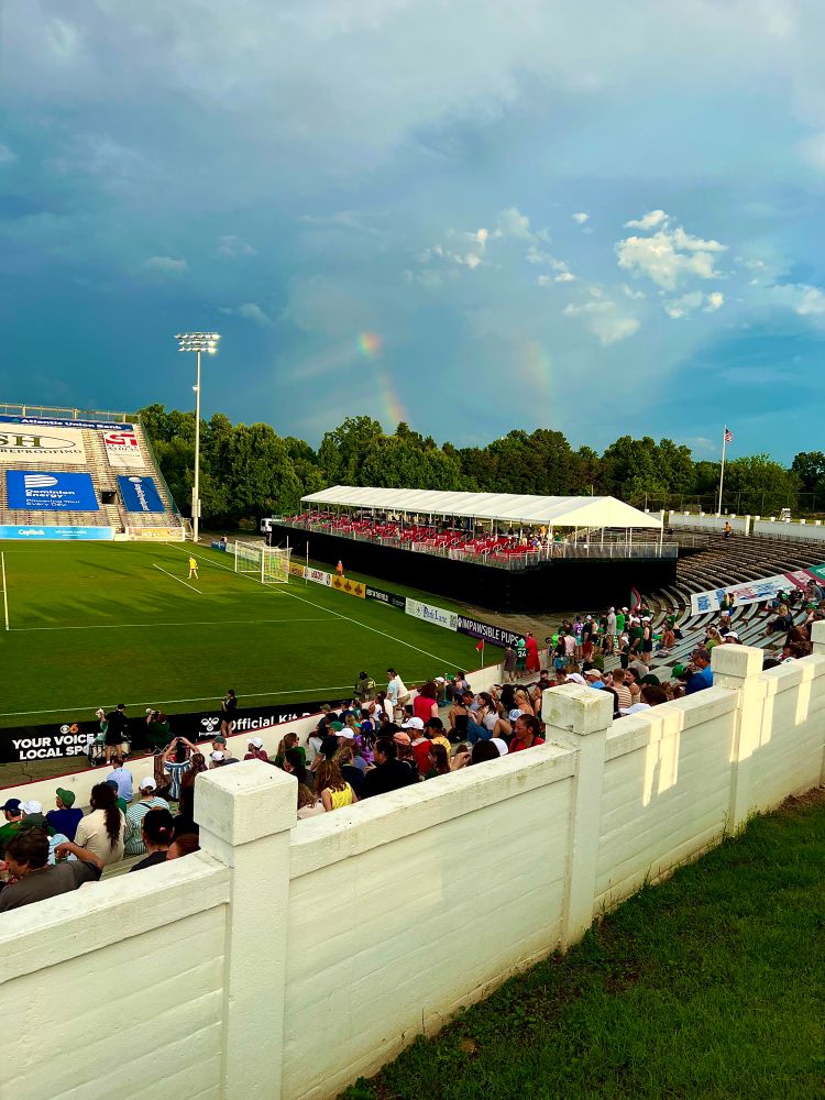 The ends of two rainbows beneath the clouds over City Stadium 