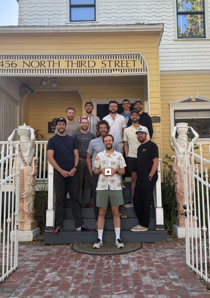 Photo of a bunch of people standing on the stairs of a house. I’m standing in the middle, holding my Apple Design Award, with the Apple logo facing the camera