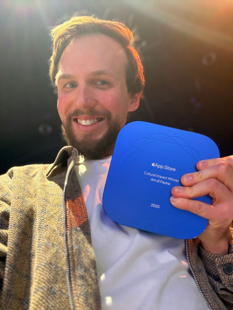 Selfie of me holding my App Store Award