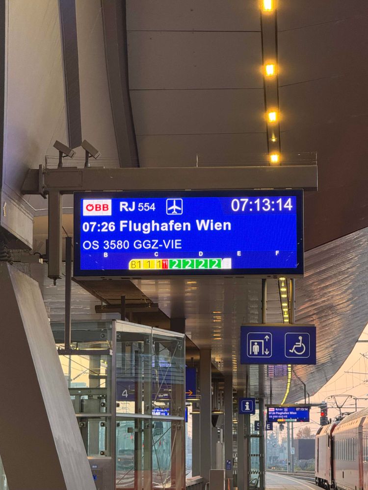Sign on the Graz Train station showing a train going to Vienna Airport at 07:26