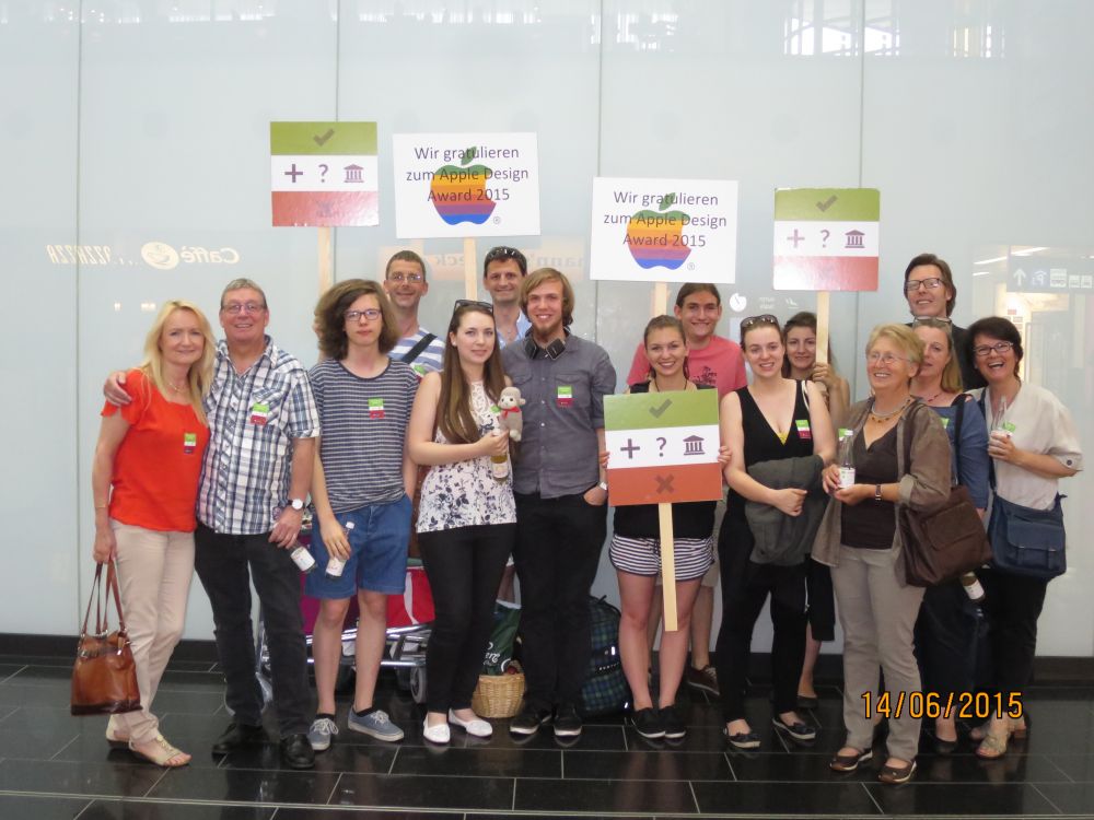 A group photo of me and my family. Everyone has an Elementary Minute sticker on. They hold signs showing the Elementary Minute icon and one that congratulates me to the Apple Design Award
