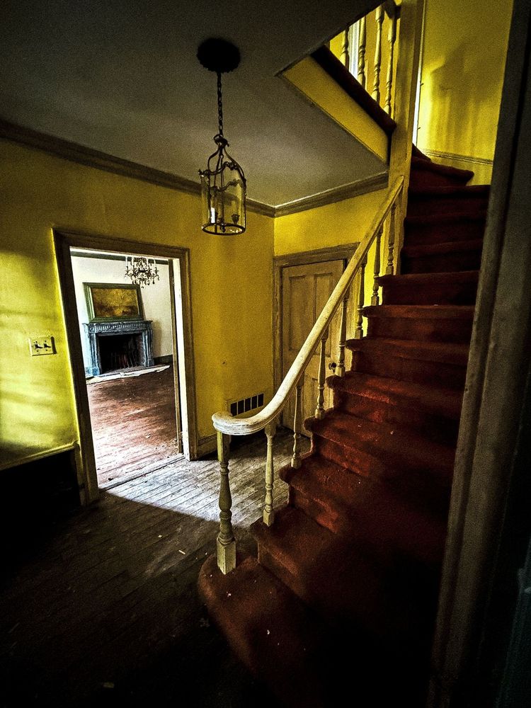 July sunlight filtering into an abandoned house somewhere in America.