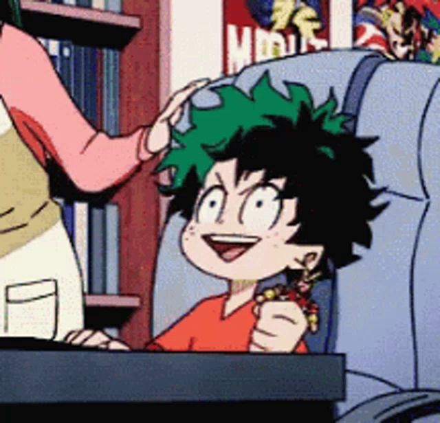 a cartoon character with green hair is sitting in a chair with a woman putting her hand on his head .