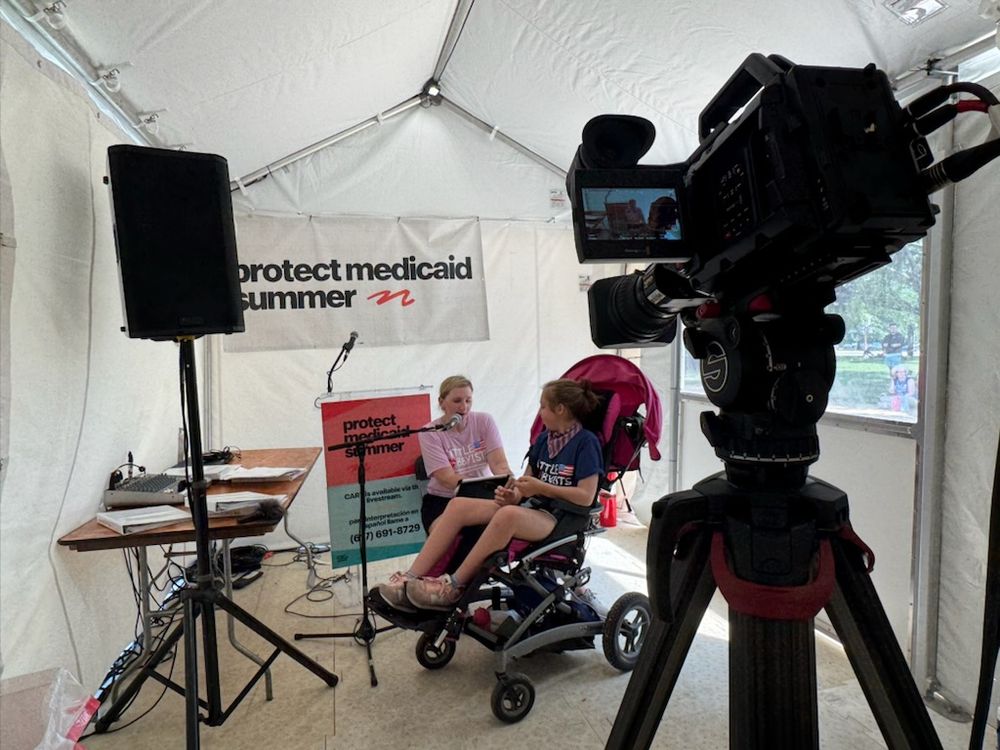 Little Lobbyists families sit in front of a livestream camera feed to read their Medicaid stories