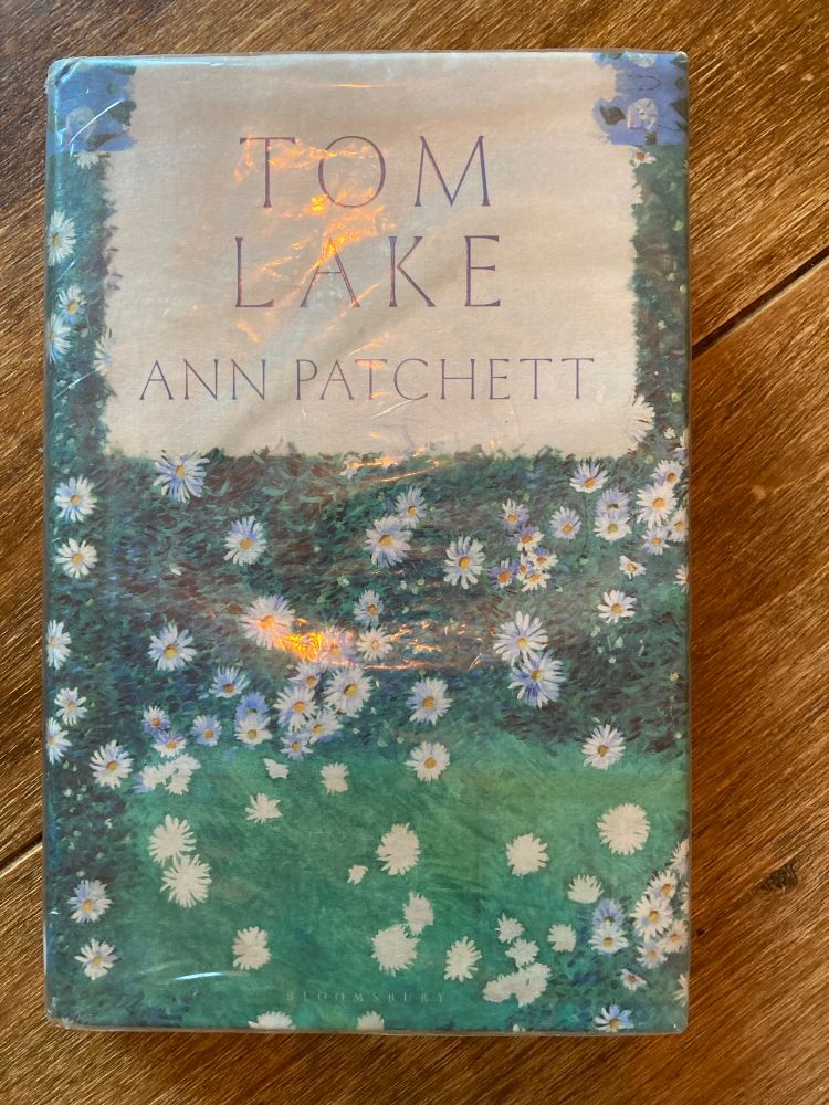 Book cover of Tom Lake by Ann Patchett showing daisies.