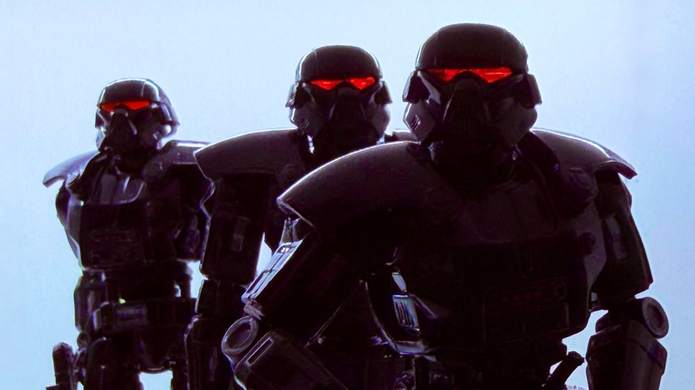 Three Hasbro Star Wars TVC Dark Trooper figures with their red eyes glowing