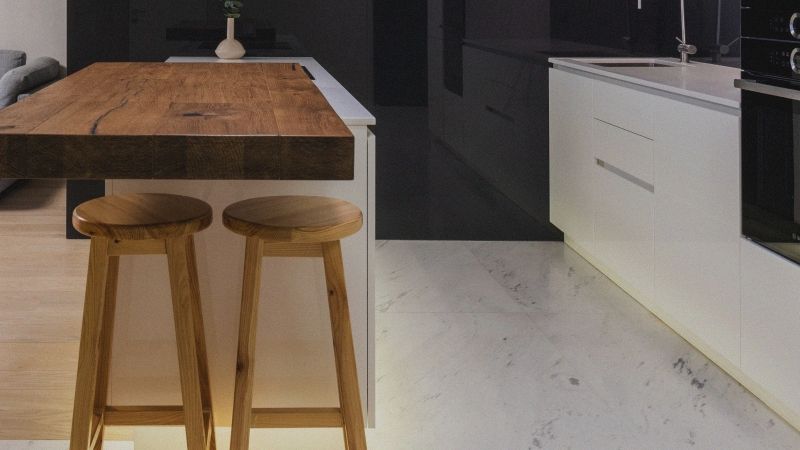 stock image of wooden stools at a kitchen island