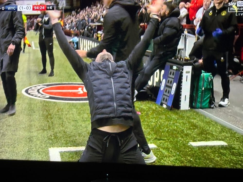 Football manager looking up to the sky. 