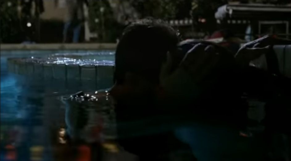 Screenshot of TV series 'Desperate Housewives' characters Andrew and Justin kissing in pool.