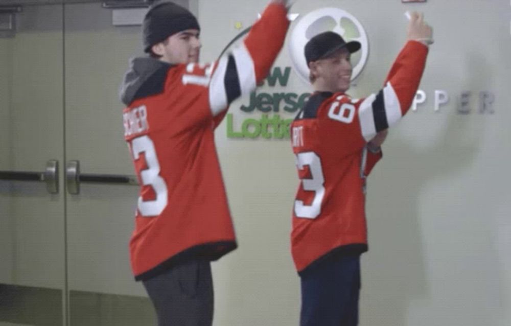 a man wearing a jersey with the number 3 on it stands next to another man wearing a jersey with the number 6 on it