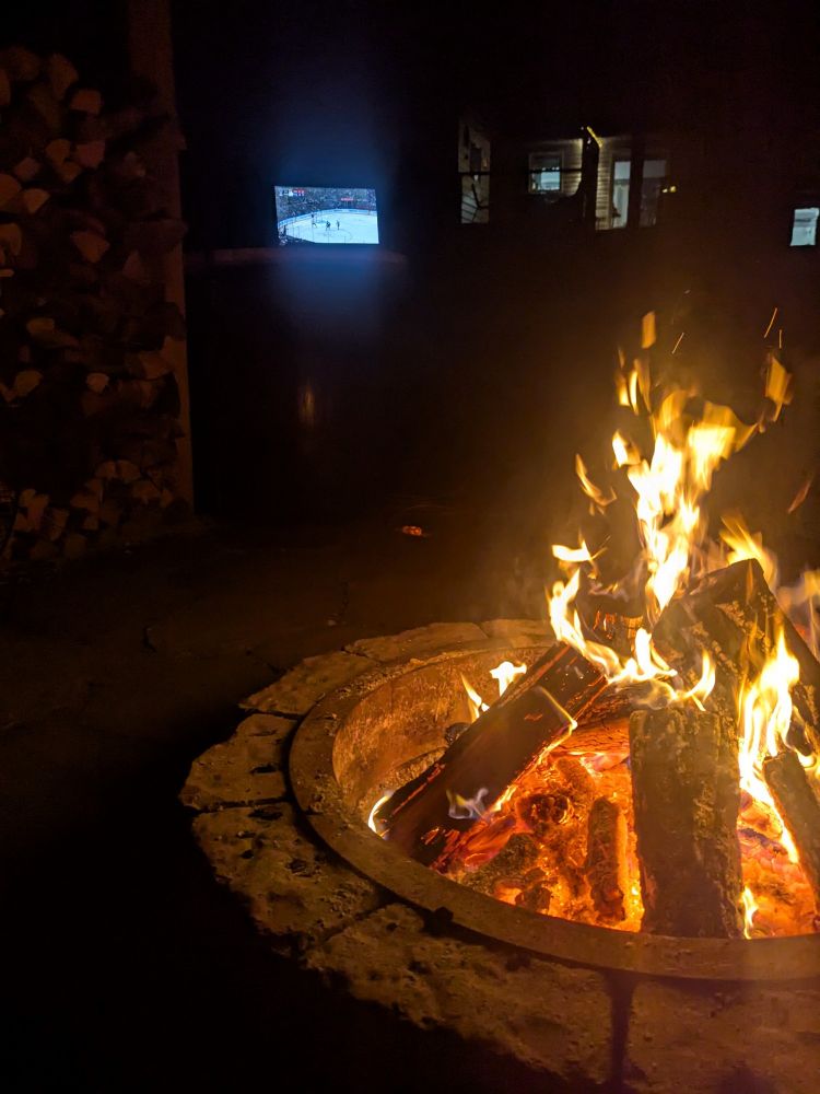 Outside camp fire watching the Toronto Maple Leafs playoffs on laptop.
