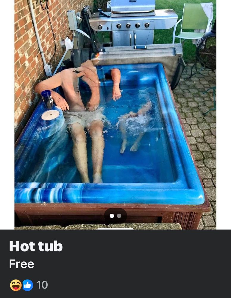 Ad for Free Hot Tub.  Photo glitch shows headless man with gaping hole in chest and detached left arm.