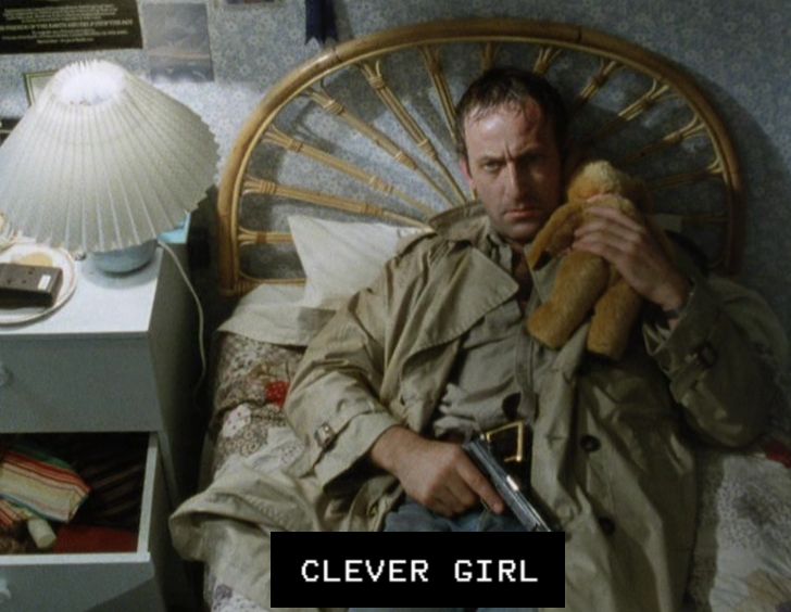 Bob Peck who played Muldoon in Jurassic Park, but in his murdered daughter's bedroom from Edge of Darkness (1985). The (FAKE) subtitles read "Clever Girl" 