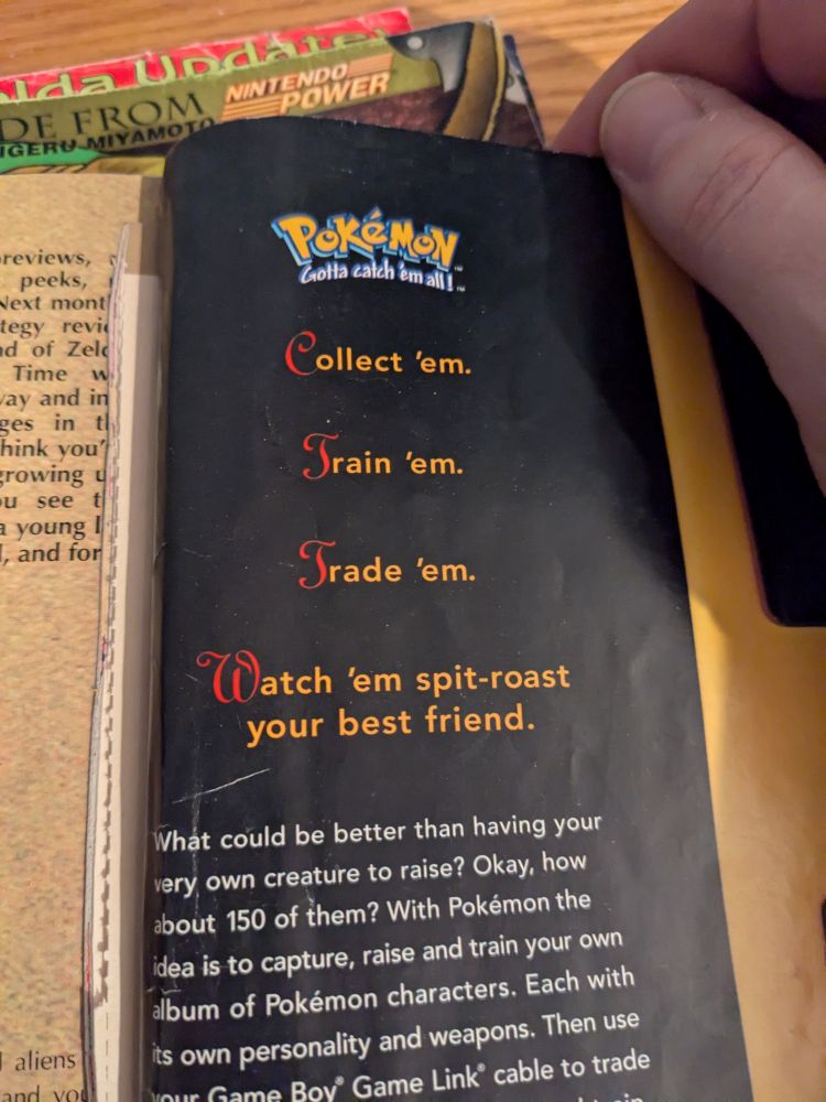 the back page ad from Nintendo Power #113, for Pokemon Red/Blue, which boldly states "Collect 'em. Train 'em. Trade 'em. Watch 'em spit-roast your best friend."