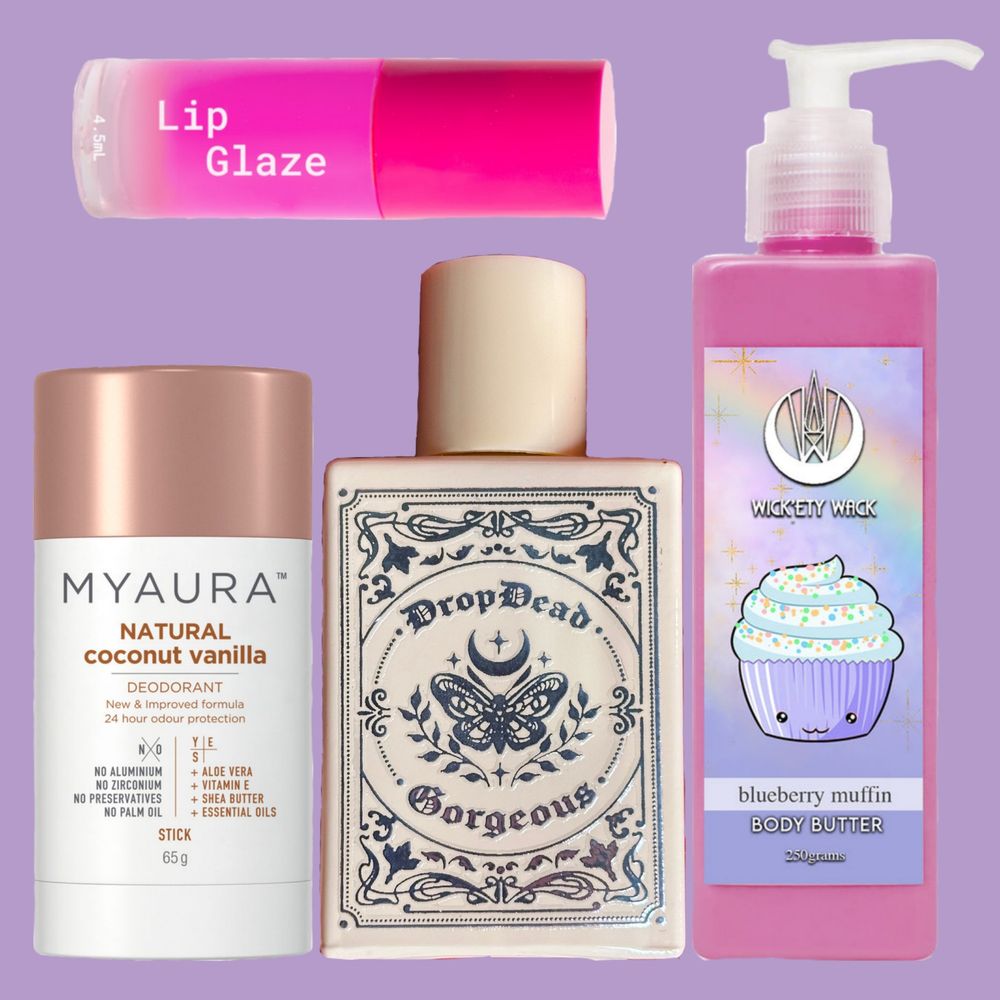 Image is a collage of the products listed on a soft pastel purple background. The lip glaze is on the top and bottom left to right is the deodorant, perfume, and body butter. The glaze is bright pink, the deodorant is a neutral white and tan colour, the perfume is a pinky cream bottle with a pretty design on the front containing a moth and crescent moon, the body butter is a purply pink with a cute little cupcake/muffin illustration on the front. 