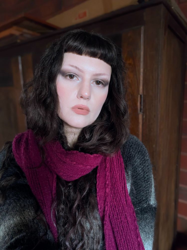 Same as the other image only in this one I have a deep pinky red scarf wrapped around my neck and hair. My expression is also more neutral in this one. 