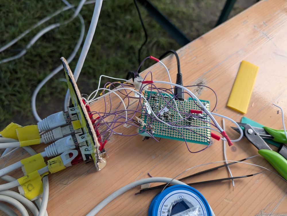 An RJ45 block in a cardboard mount, connected via a ratsnest to a a protoboard 