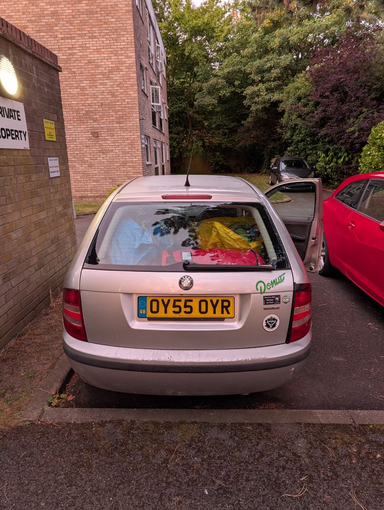A silver Skoda Fabia, full of stuff. 