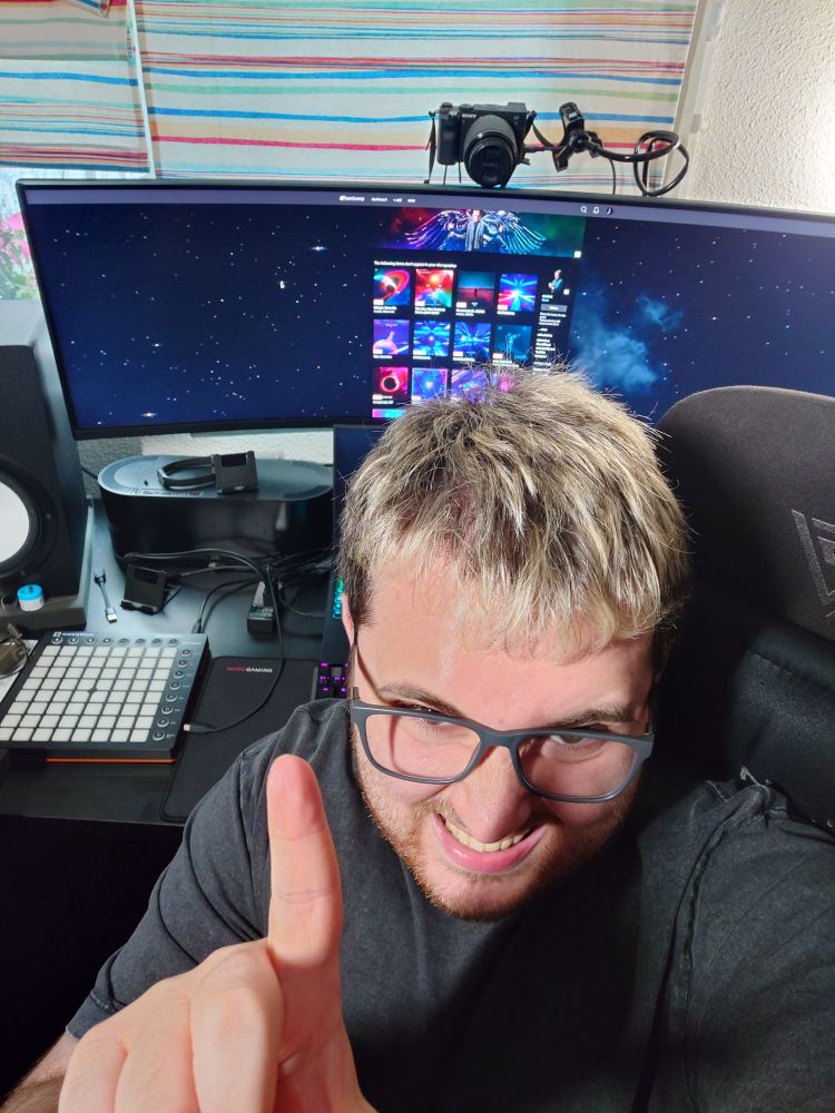 modus sits in his studio, pointing excitedly to his computer display showing his new Bandcamp page