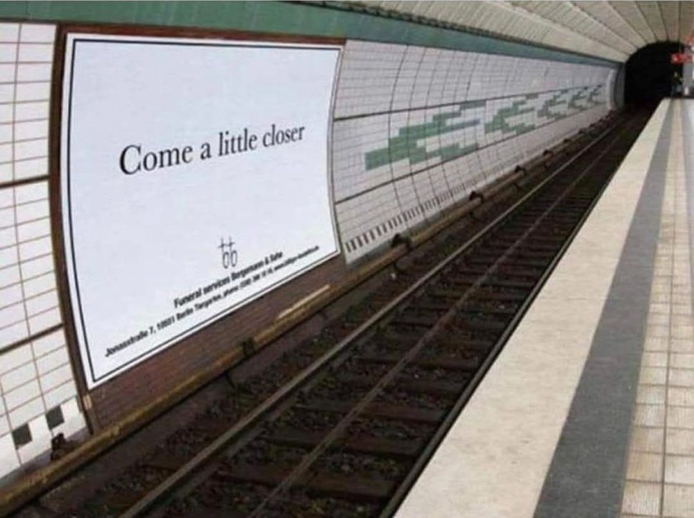 Sign in train station, over the tracks, says 