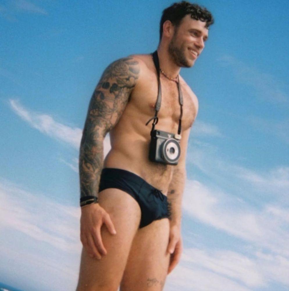 Gus Kenworthy suited up in a speedo.
