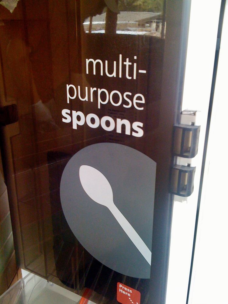 a sign offering "multi-purpose spoons". 