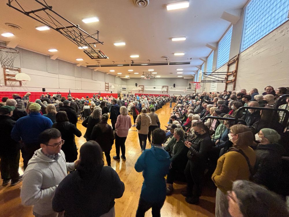 A middle school gym filled with people 