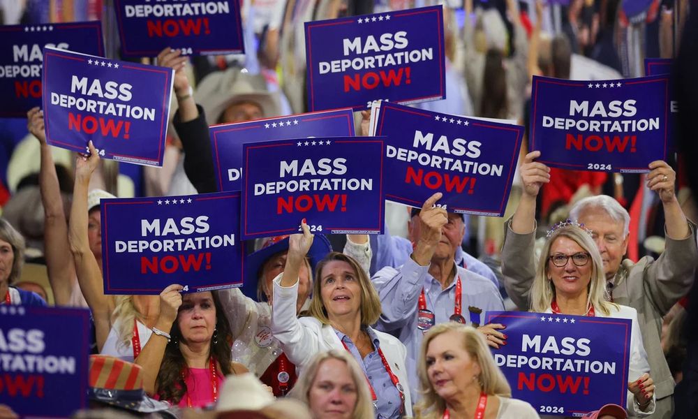 White people waving “mass deportations now” signs at the 2024 RNC