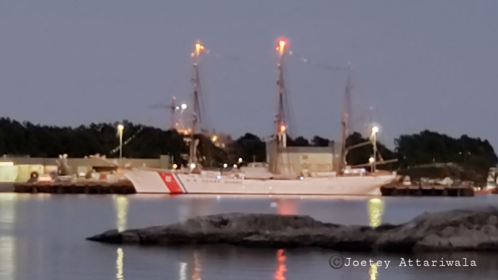 Seen is an image of USCGC Eagle at dusk in Victoria, BC, Canada on 15 July 2025. USCGC Eagle is a 295-foot (90 m) barque used as a training cutter for future officers of the United States Coast Guard. 