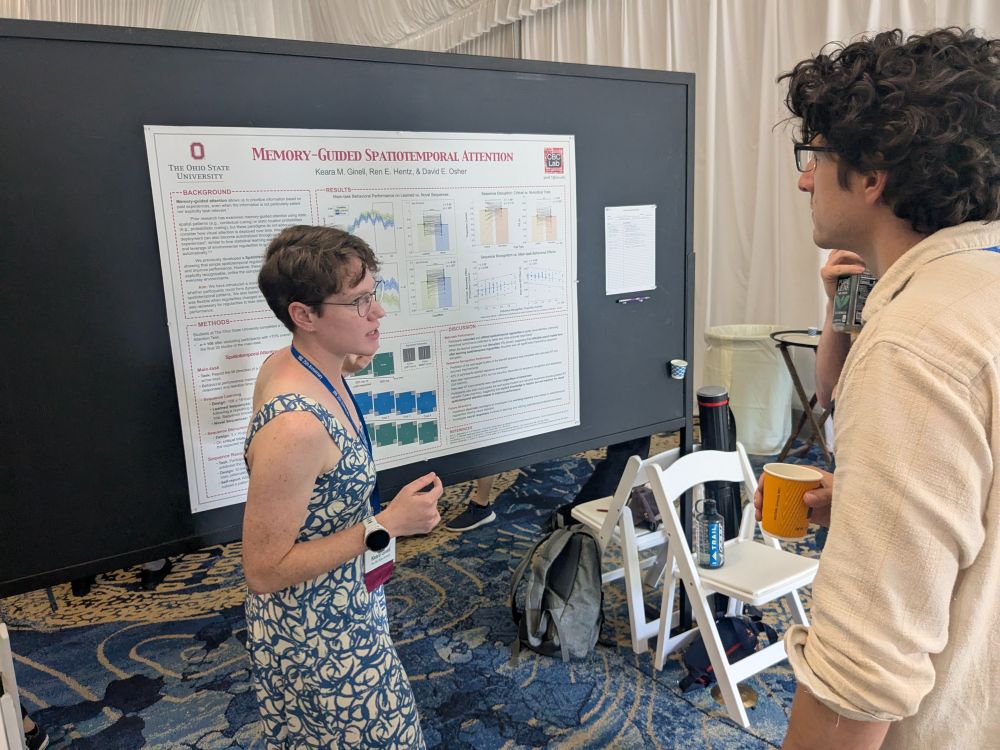 Keara explains her research poster, entitled "Memory-Guided Spatiotemporal Attention", to a fellow Vision Sciences Society conference attendee.