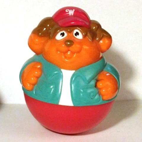 Bumpus Wobbleworks figure from Weebly Wobbly Tree House playset (2005). Orange sheepdog with brown headfur and no legs wearing a white shirt, teal jacket, red bottom, and red ball cap with white W insignia.