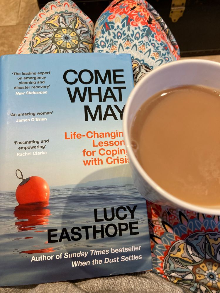 Come what may book with cup of tea. Matching PJ trousers underneath orange / blue entirely coincidental.