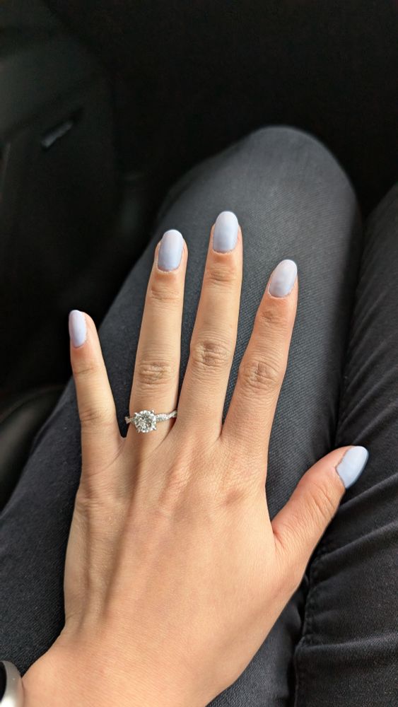 My nails painted a periwinkle/light blue matte colour