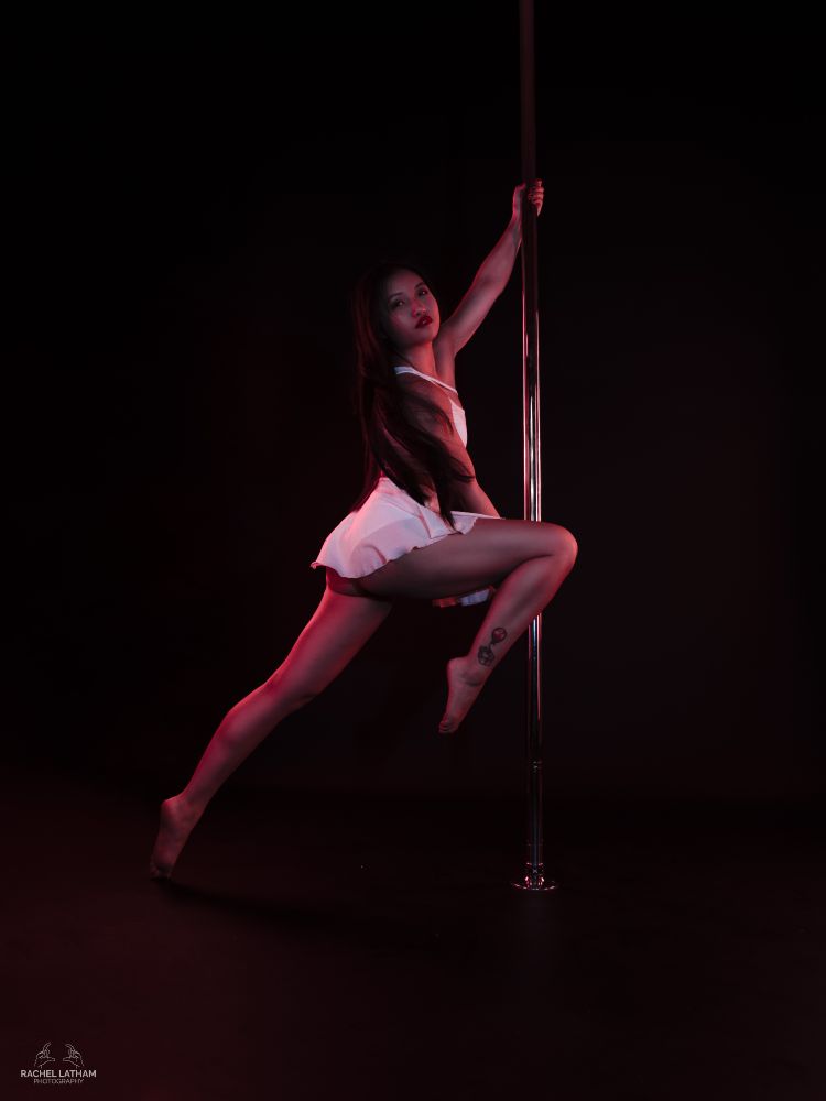 A professional photo of me holding a stag leg position upright on the pole