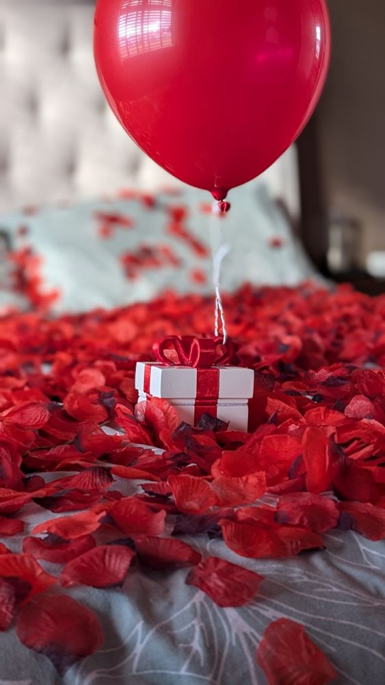 An Animal Crossing inspired ring box on a bed of rose petals