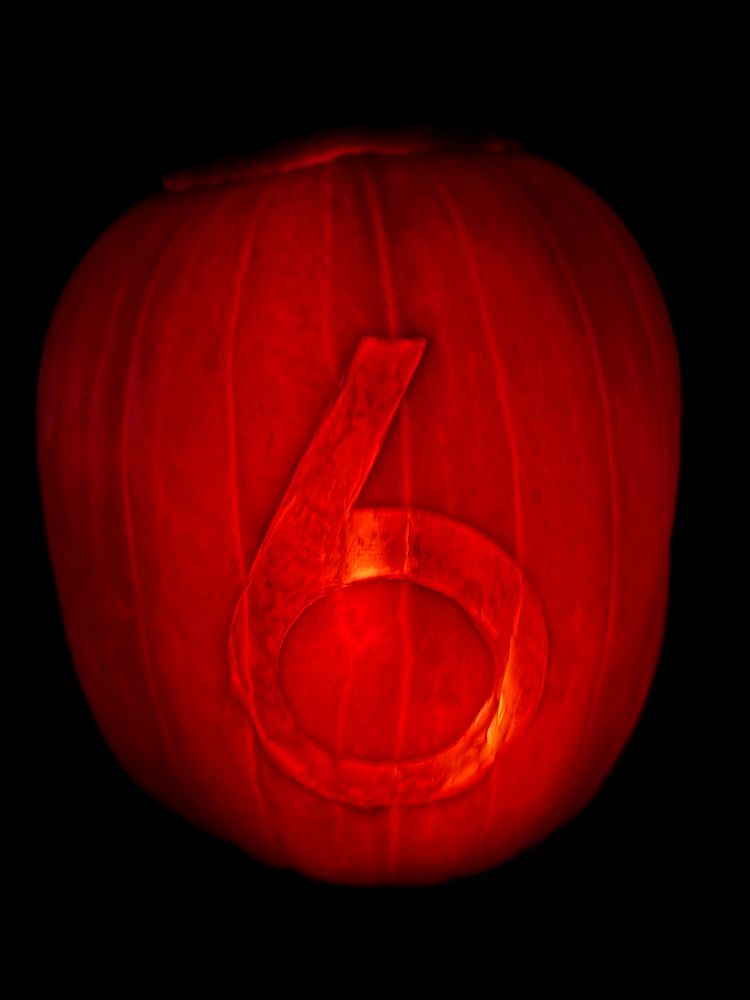 A glowing pumpkin with a numeral 6 inscribed in it