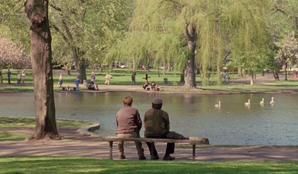 A scene from the film Good Will Hunting. Will (played by Matt Damon) and Dr. Sean Maguire (played by Robin Williams) sit at a park bench facing the lake at Boston Common watching the swans swim by.