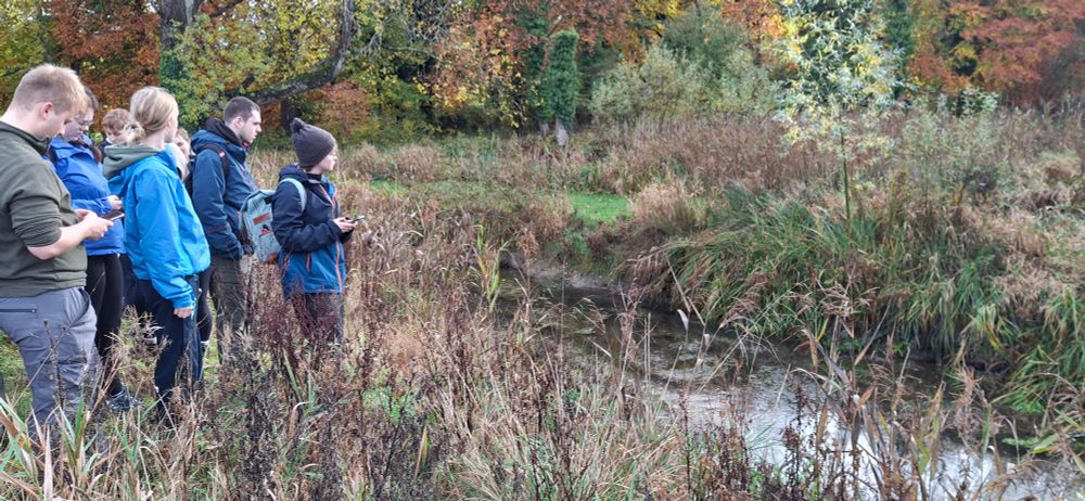 Students looking at Driffield Trout Stream, one of the most northerly chalk streams in the UK. 
