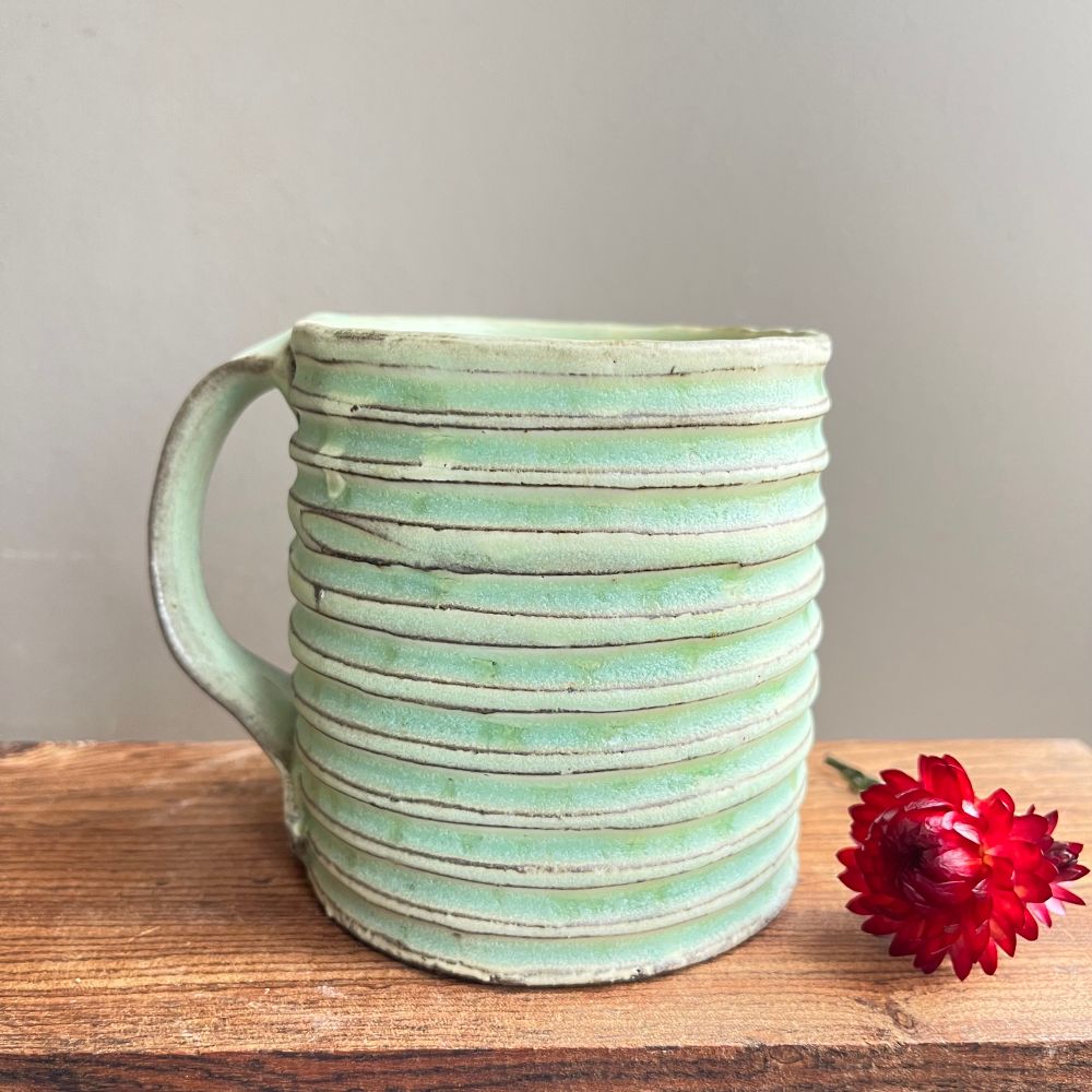 Carved mug with horizontal lines 