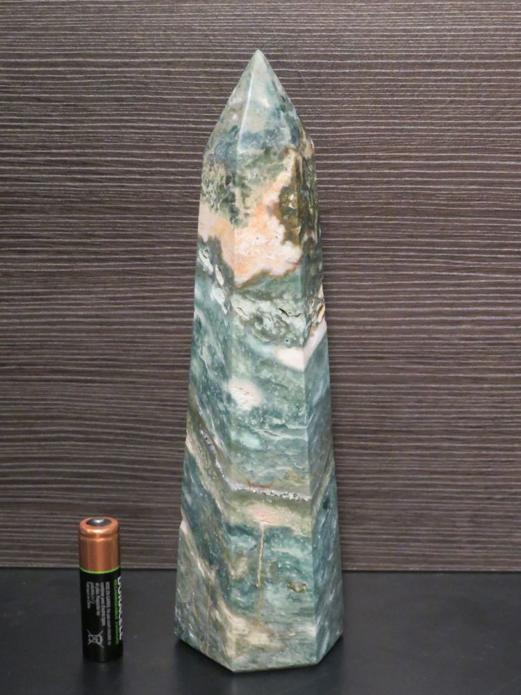 Obelisk of Ocean Jasper with a AA battery for scale.