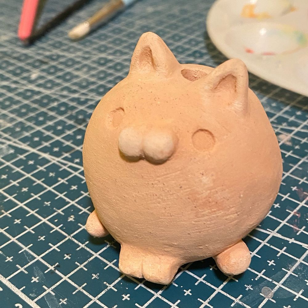 a round fat ceramic cat