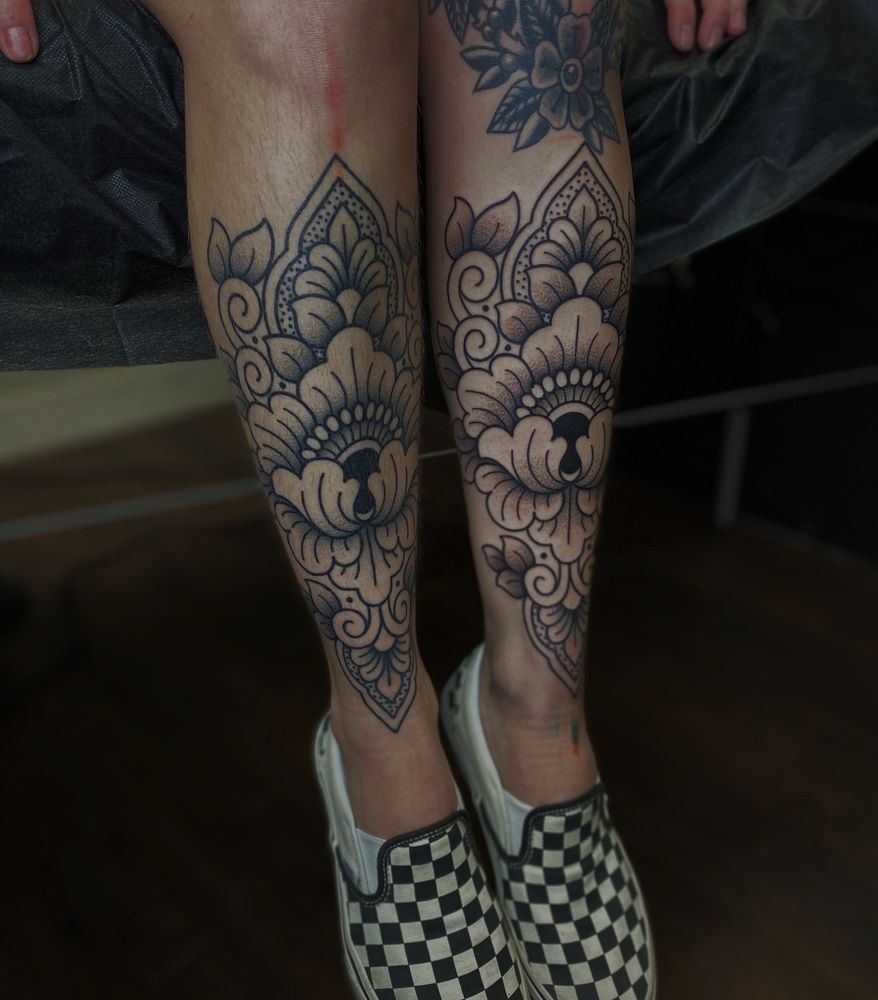 Symmetrical ornamental shin tattoos by Veronica Musser Tattoo