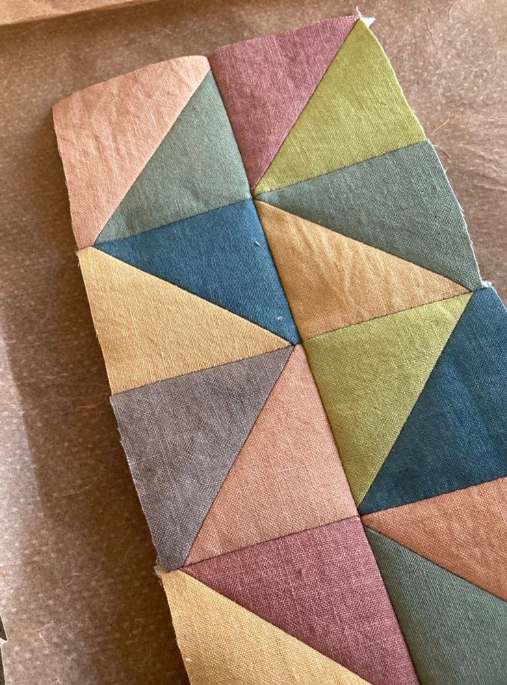 Linen triangles patchworked into a muted but striking palette of blues, yellows and pinks