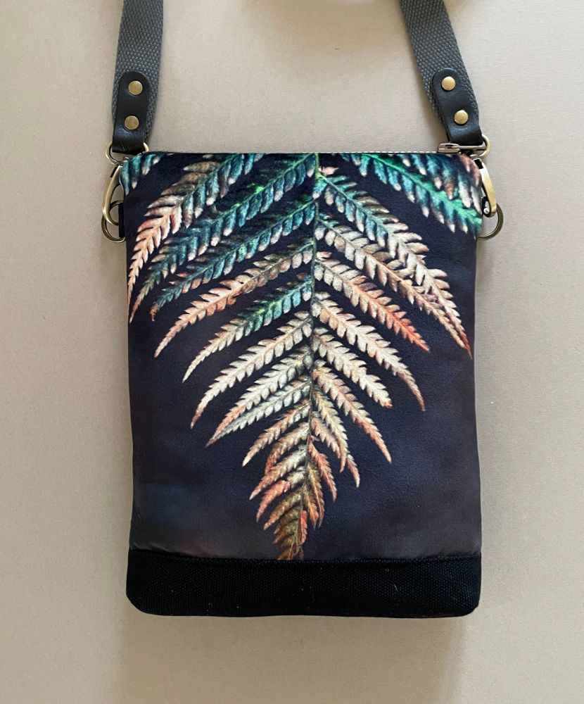 A handmade shoulder bag featuring a velvet printed panel of a fern frond in a brown, gold, green and black colourway 