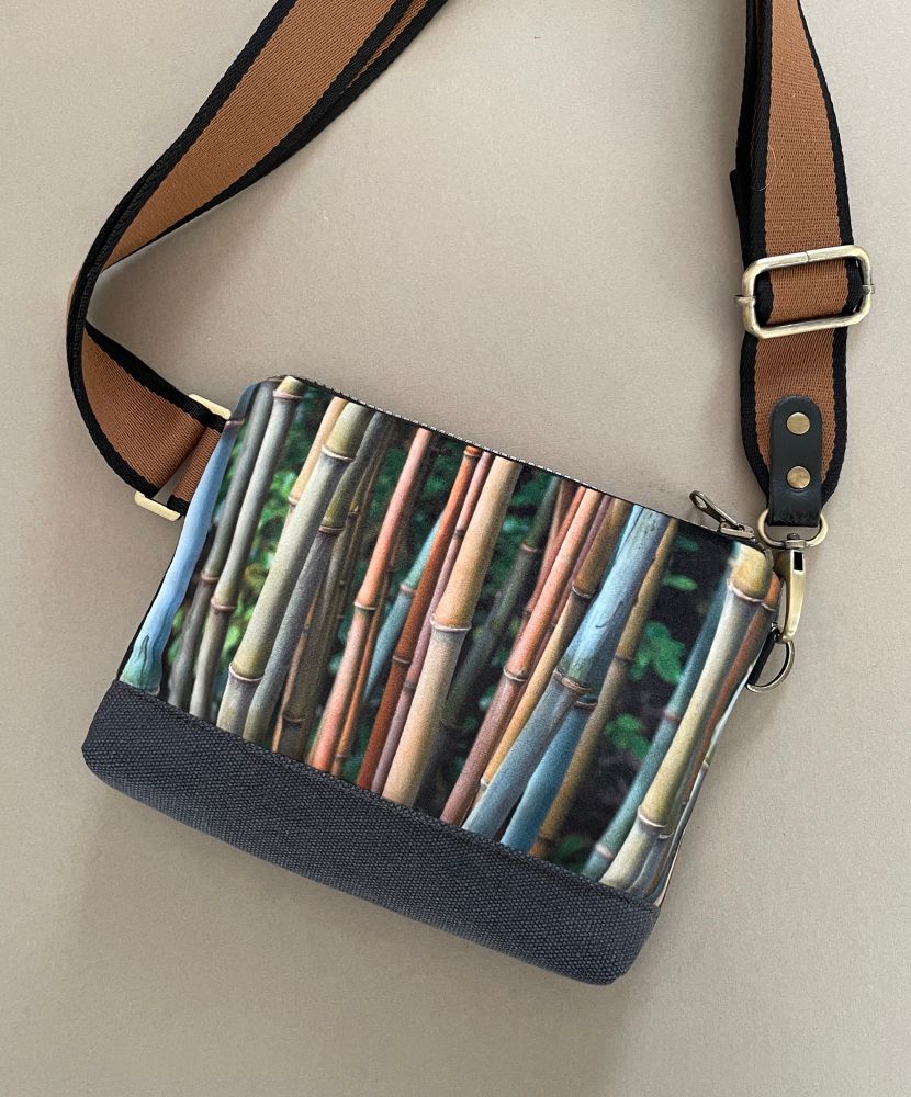 A handmade shoulder bag featuring a velvet printed panel of bamboo stems in a muted green, blue and brown colourway 