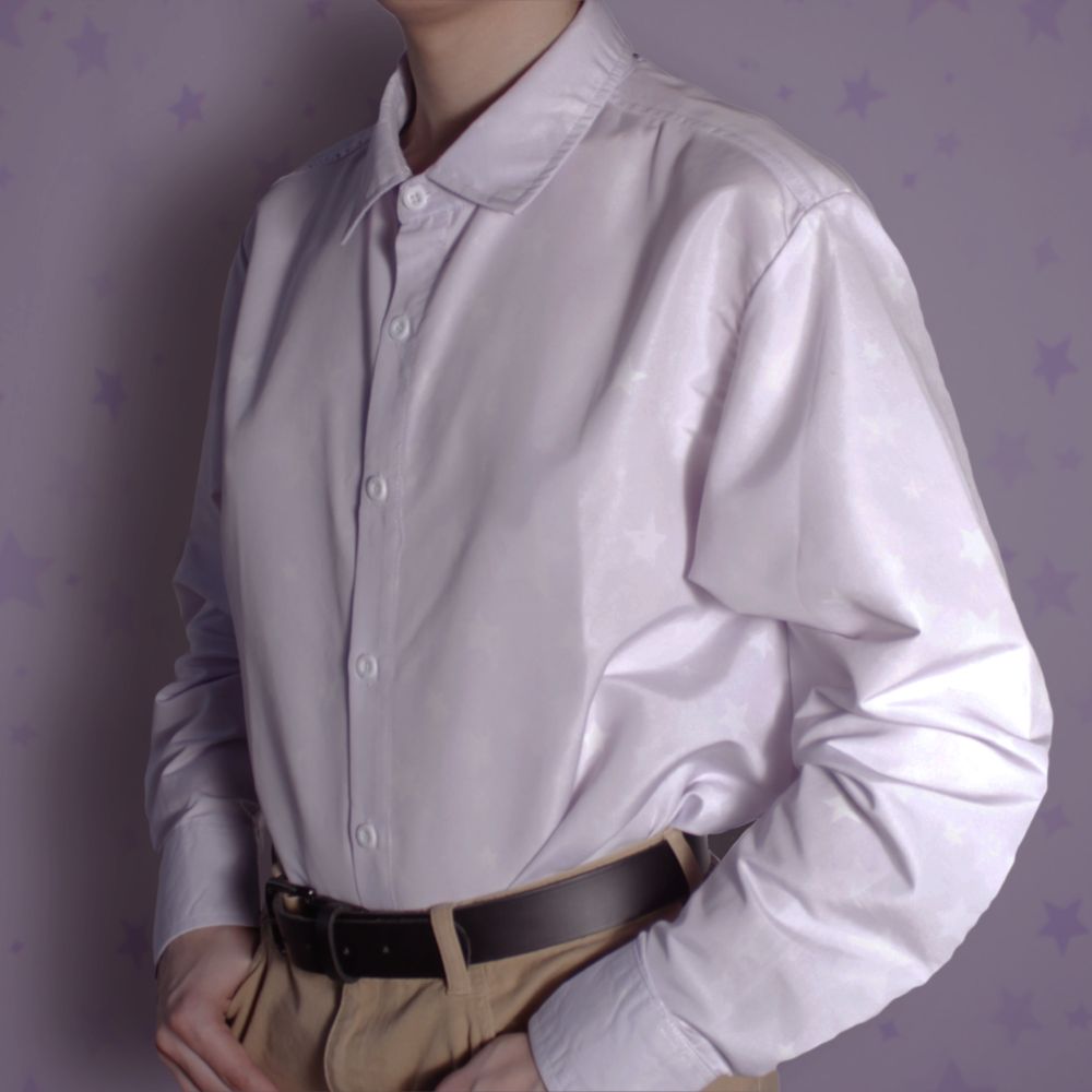 A long sleeve white button up shirt tucked into pants, with a subtle star pattern covering it.